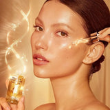 Glowing skin application of Charlotte Tilbury Collagen Superfusion Facial Oil dropper dispensing oil onto hand with radiance