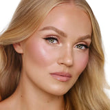 Charlotte Tilbury highlighter texture close-up showing silky smooth powder with luminous particles