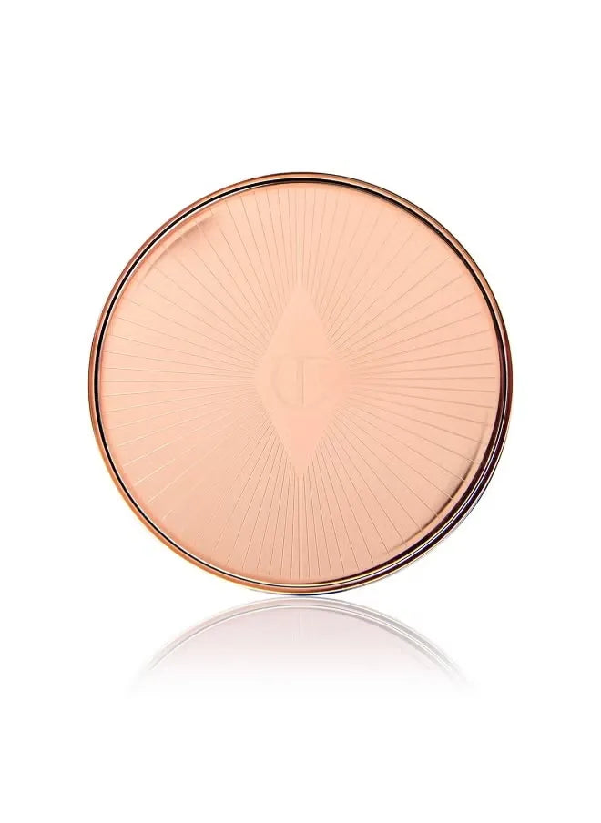 Swatch of Charlotte Tilbury Pillow Talk Lip and Cheek Glow in Colour of Passion showing a deep berry-pink tint