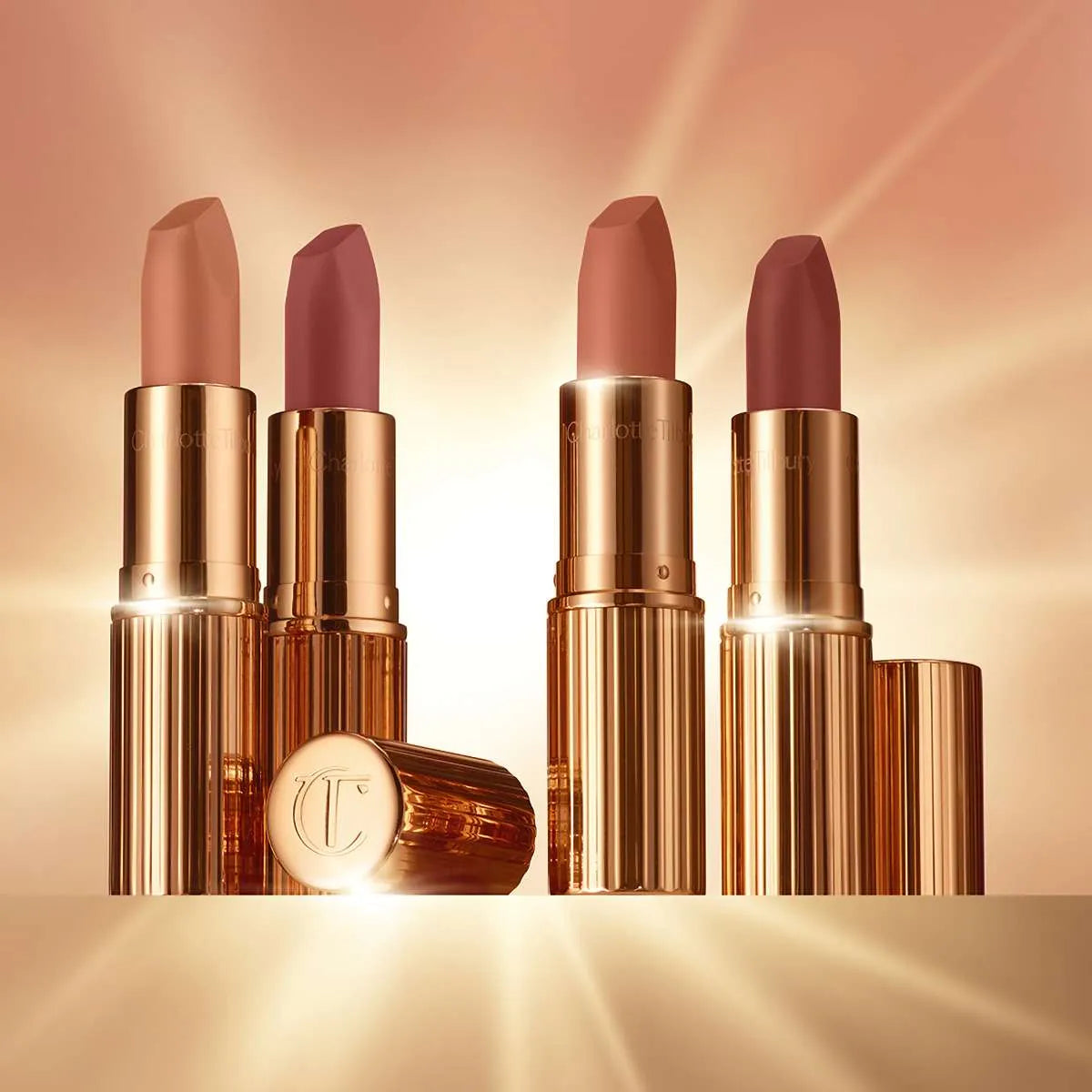 Model wearing Charlotte Tilbury Cover Star lipstick for a 90s-inspired nude lip