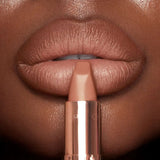 Charlotte Tilbury Cover Star lipstick applied on lips for a matte nude look