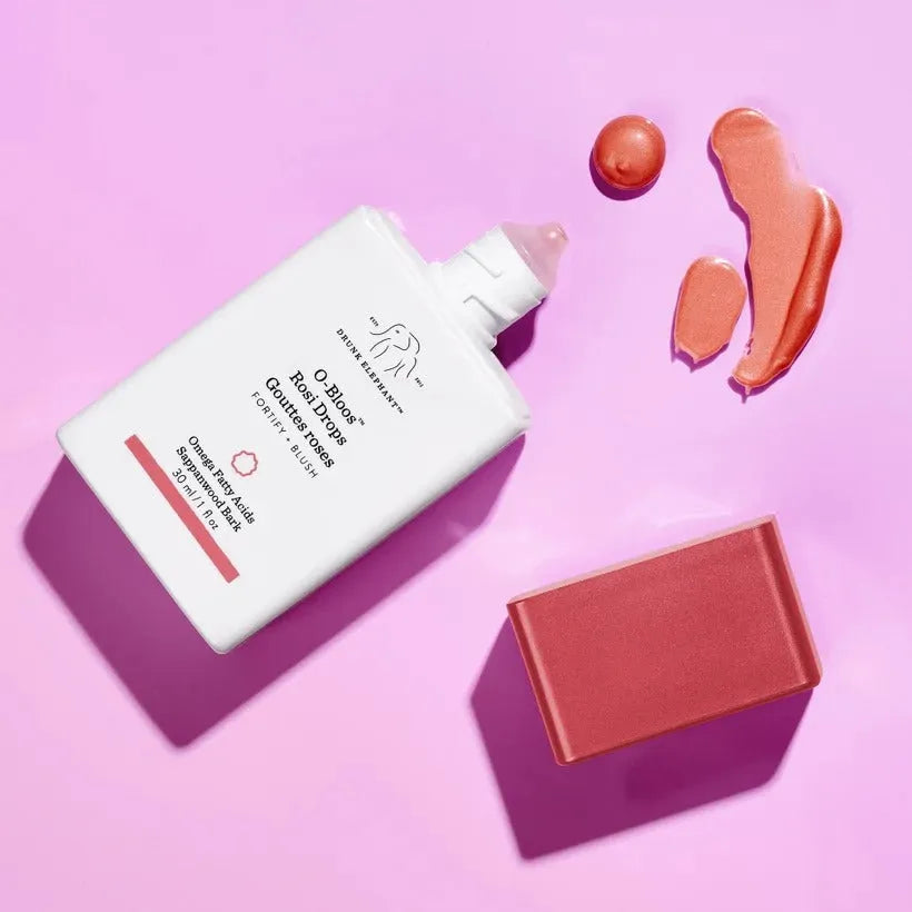 Drunk Elephant O-Bloos Rosi Drops swatch on skin showing warm pink flush