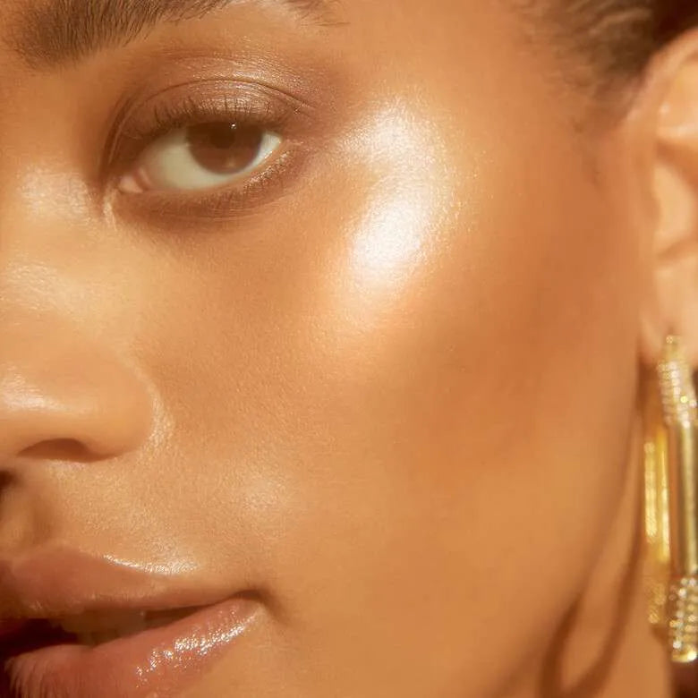 Model wearing E.L.F. Halo Glow Liquid Filter for a dewy glowing look
