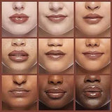 Fenty Beauty Gloss Bomb Lip Luminizer Fu$$y swatch on a finger showing sheer pink with pearl shimmer