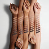Swatch of Fenty Beauty Amber Suede contour stick on medium skin tone showing warm brown color