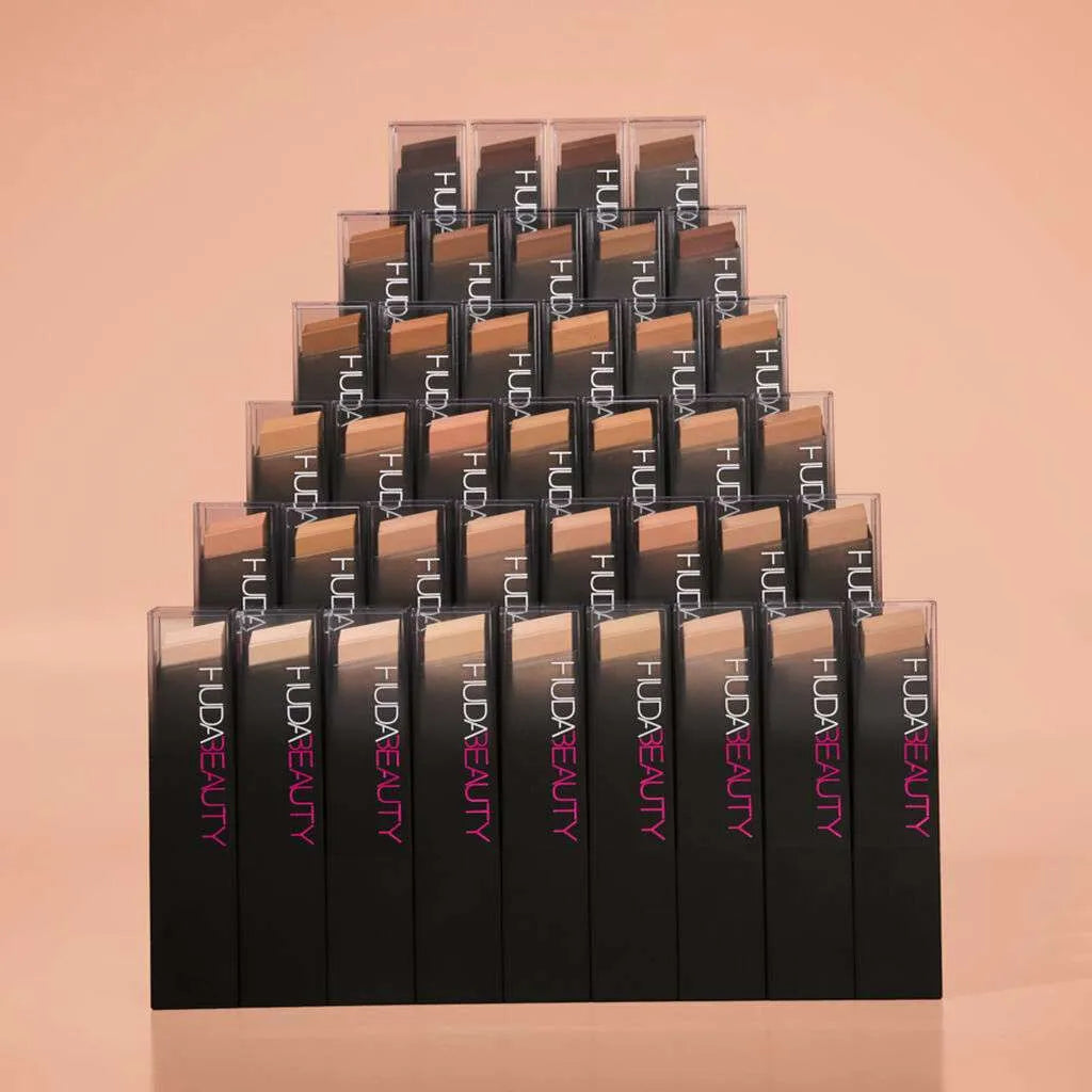 Huda Beauty buildable coverage foundation stick collection with other shades and products