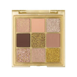 Open Huda Beauty Gold Obsessions palette showing nine gold shades from matte to shimmer