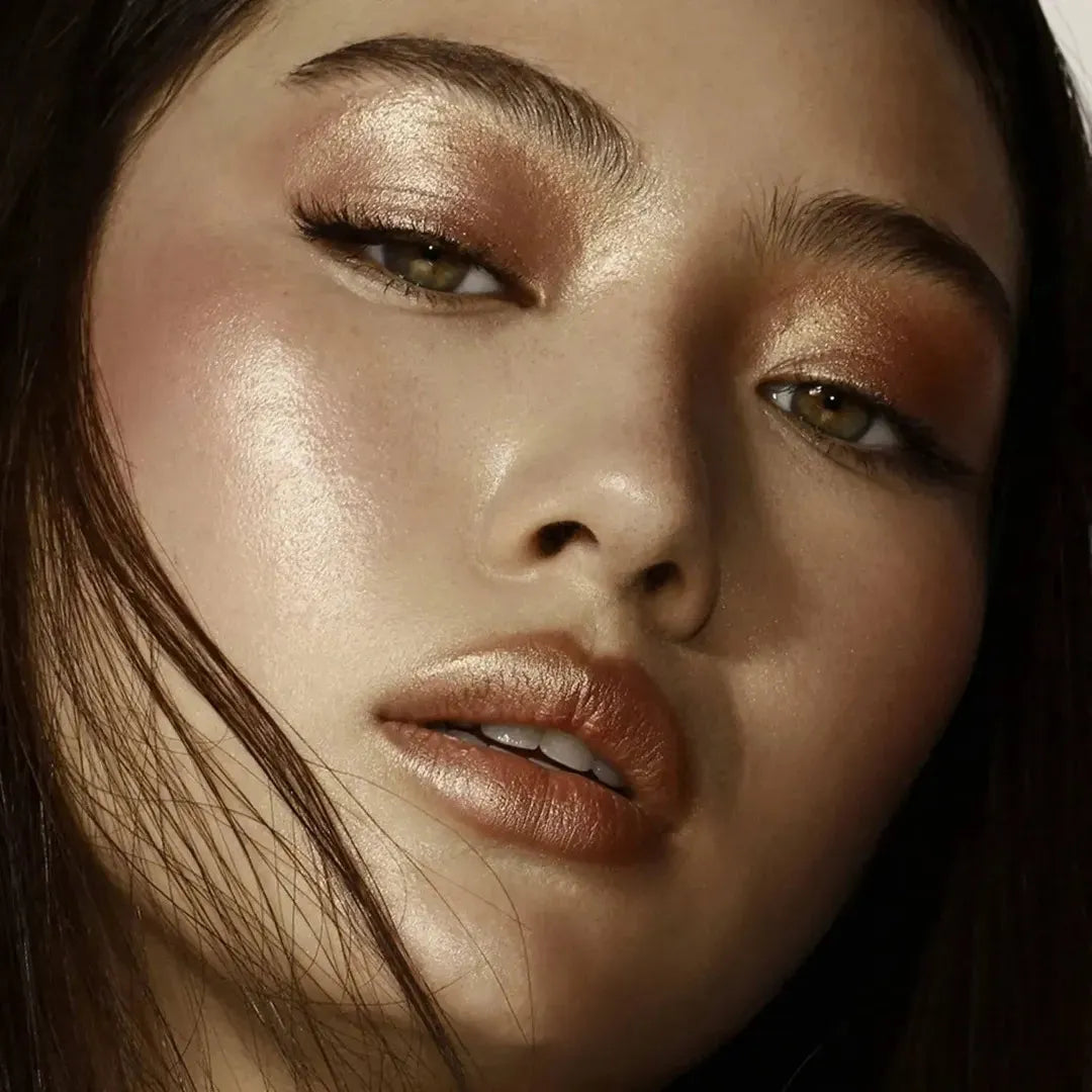 The Natasha Denona Bloom Face Glow Palette open, revealing the four distinct pan formulas: glow cream base, cream blush, duo chrome, and metallic powder highlighter, showcasing their vibrant colors and textures.