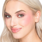 Model wearing Too Faced Cloud Crush Blush Tequila Sunset on cheeks with natural flush