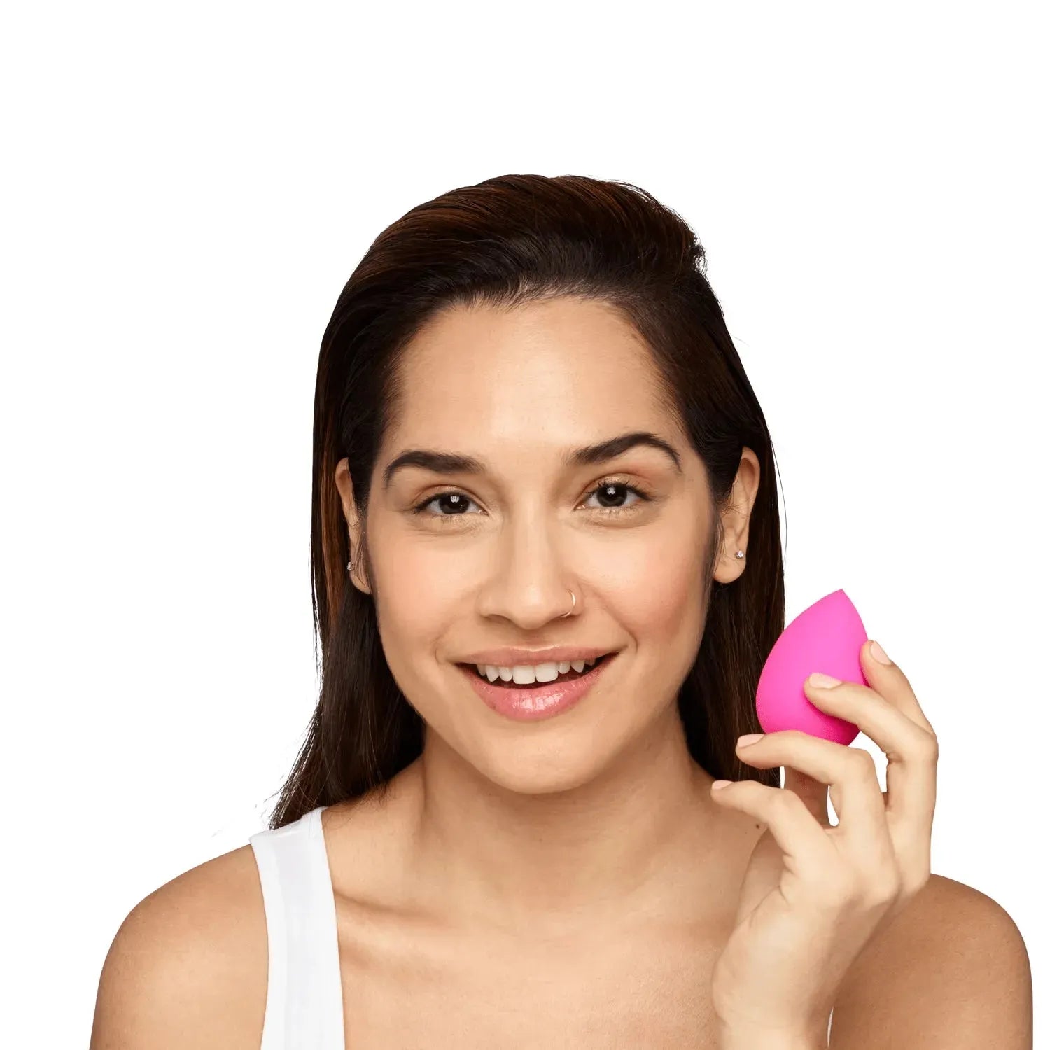 Beautyblender sponge next to a foundation bottle for makeup application and beauty routine essentials