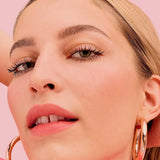 Close-up of Benefit They're Real! mascara wand bristles showing staggered design for lengthening and volumizing