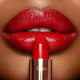 Charlotte Tilbury K.I.S.S.I.N.G Lipstick So Red - Swatch on an arm showing rich red pigment