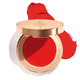 Close-up of Charlotte Tilbury Pinched Cheek Glow dewy blush swatch on cheeks showing radiant finish