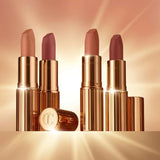Model wearing Charlotte Tilbury Cover Star lipstick for a 90s-inspired nude lip