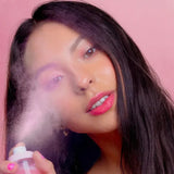 Close-up of women spraying the ultra-fine mist over face for hydration