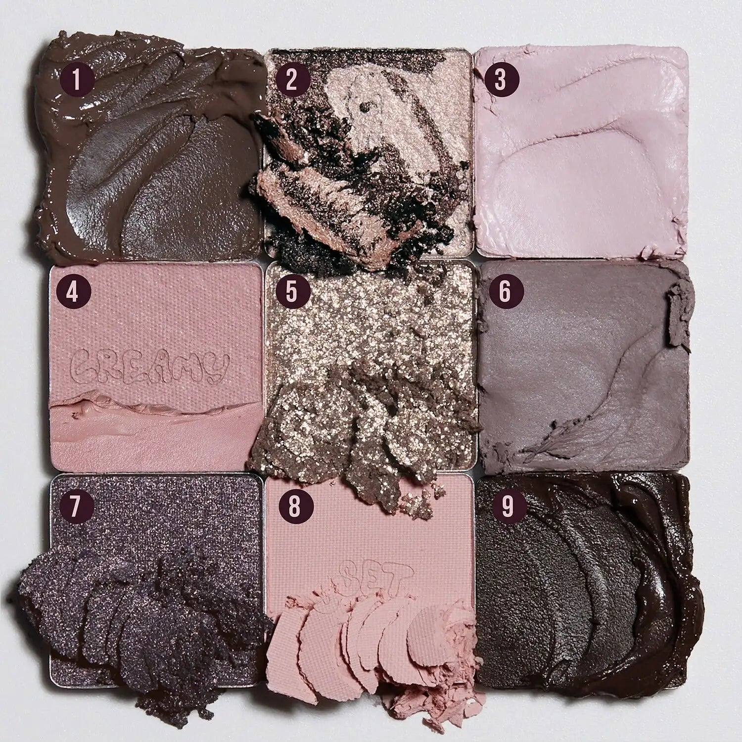 Swatches of Huda Beauty Greige Creamy Obsessions palette on skin showing creamy, metallic and matte textures