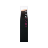 Close-up of Huda Beauty FauxFilter Foundation Stick creamy texture in 150G Creme Brulee