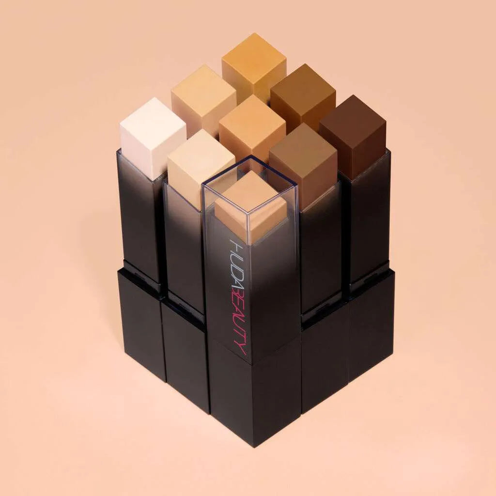 Group shot of Huda Beauty FauxFilter Foundation Stick shades including 150G Creme Brulee