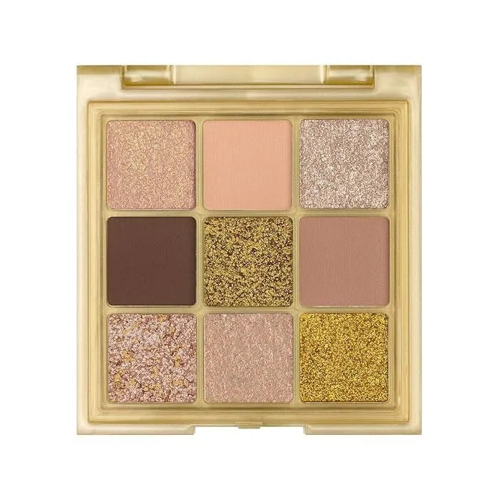 Open Huda Beauty Gold Obsessions palette showing nine gold shades from matte to shimmer
