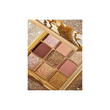 Close-up of Huda Beauty Gold Obsessions palette with gold metallic shade and shimmer topper