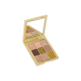 Huda Beauty Gold Obsessions palette tilted view showing gold flakes in shadows