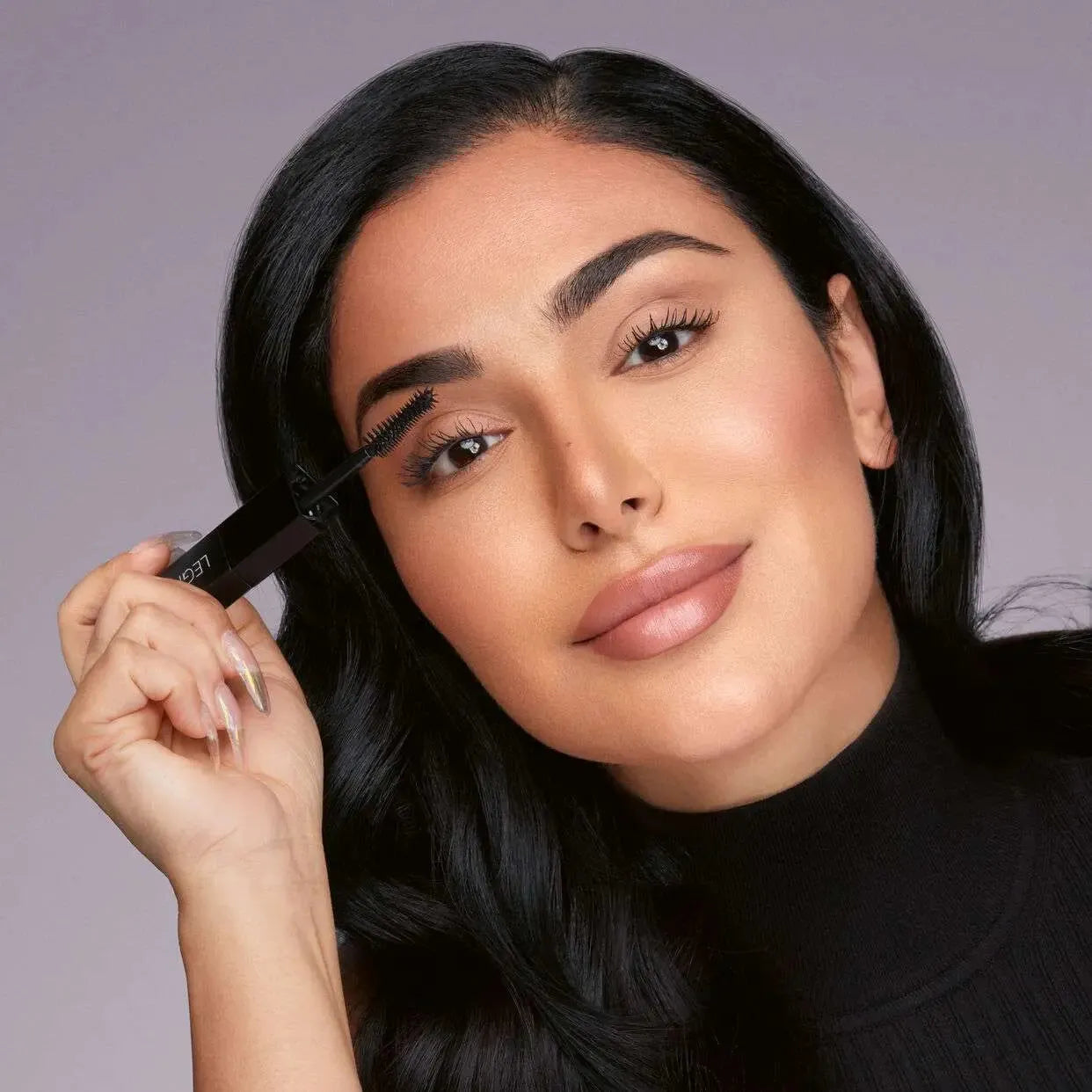 Model wearing Huda Beauty Legit Lashes mascara with voluminous long lashes