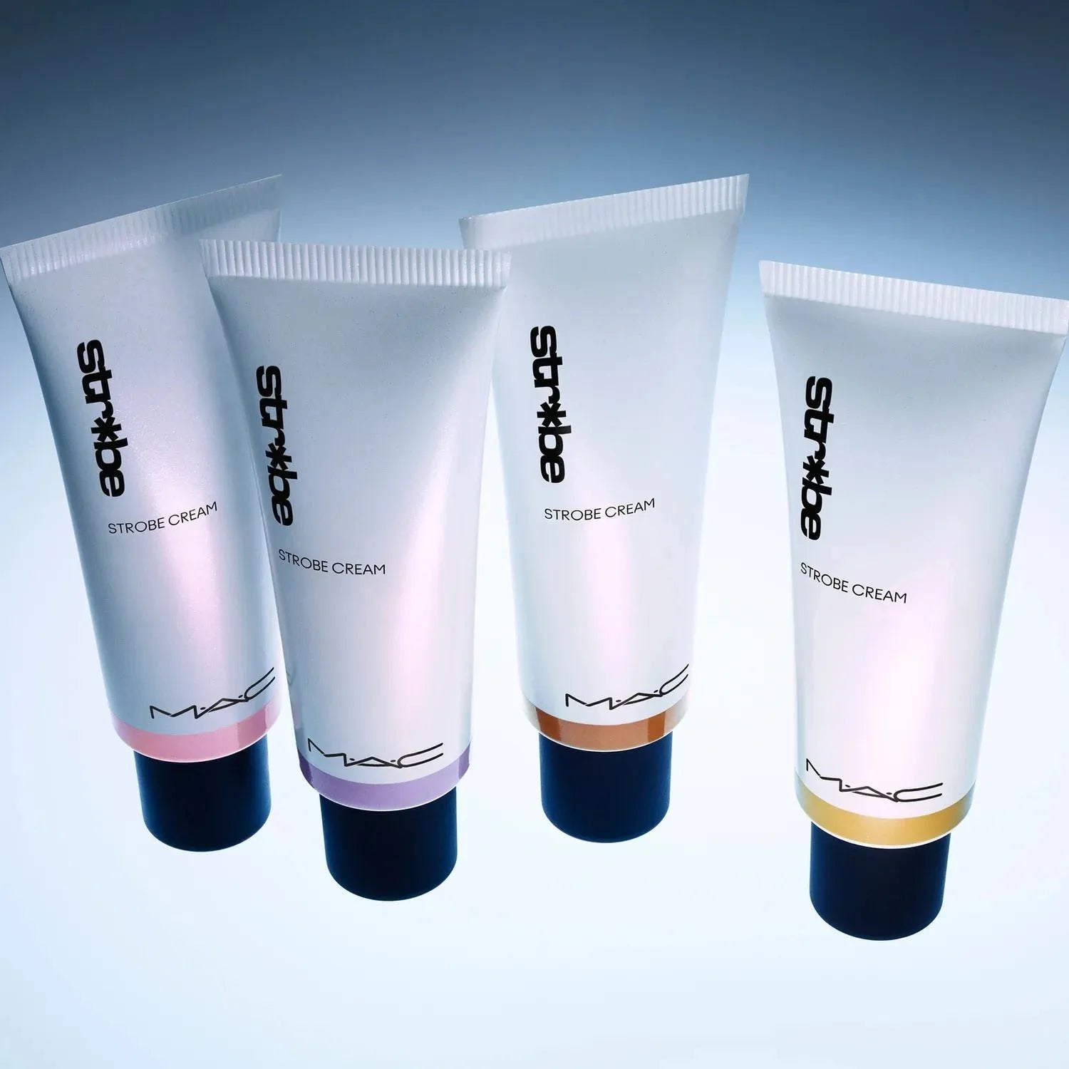 Application of MAC Strobe Cream Goldlite on cheekbones for a radiant highlight