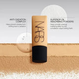 Applying NARS Soft Matte foundation Valencia with brush
