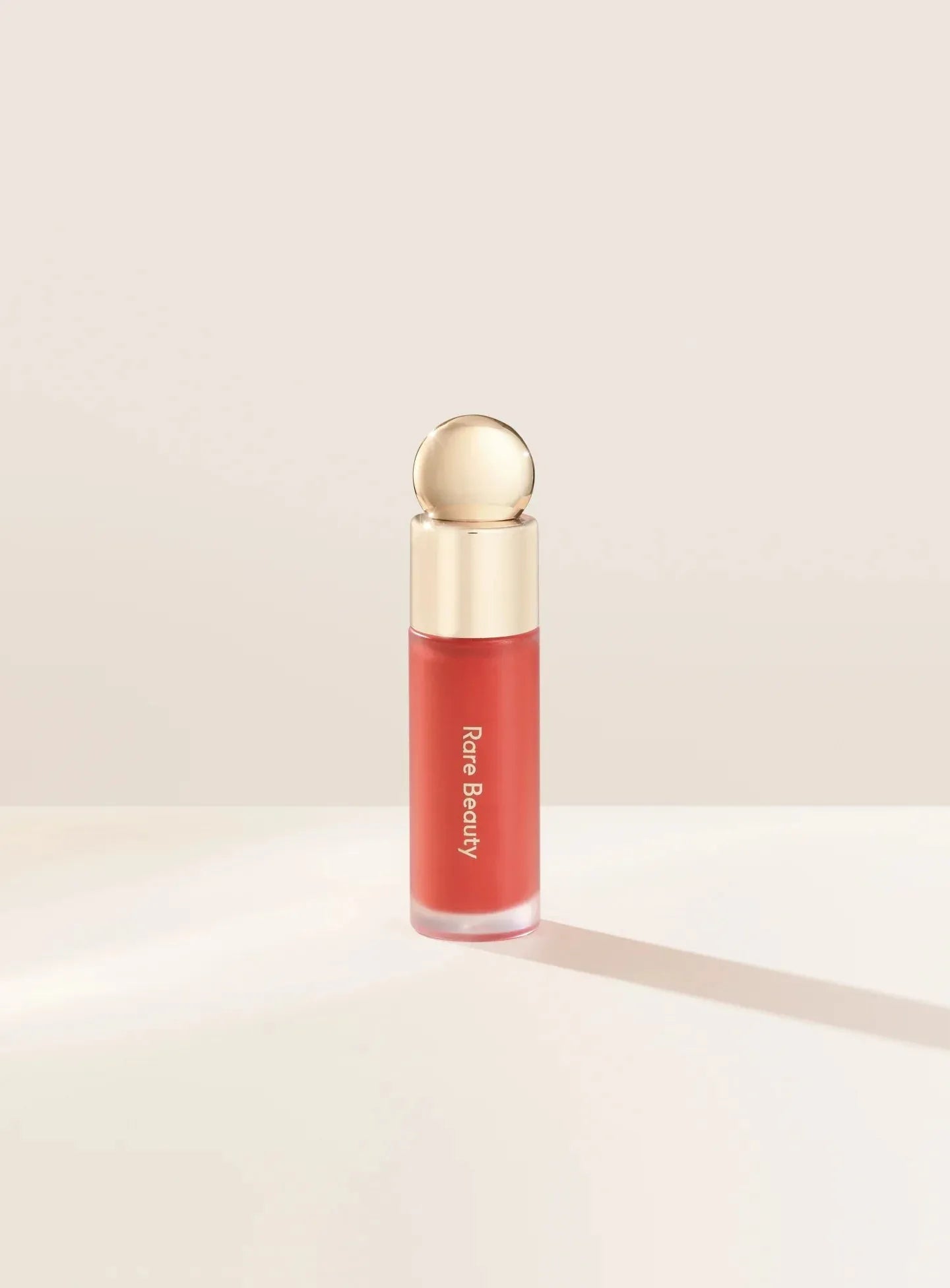 Rare Beauty Soft Pinch Liquid Blush Joy dewy muted peach shade product bottle
