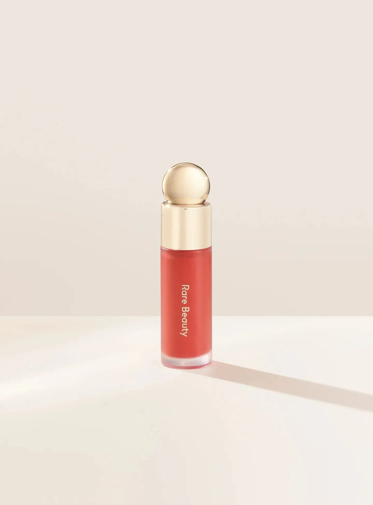 Rare Beauty Soft Pinch Liquid Blush Joy dewy muted peach shade product bottle