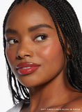Close-up of model with Rare Beauty Soft Pinch Liquid Blush in Virtue beige peach dewy finish