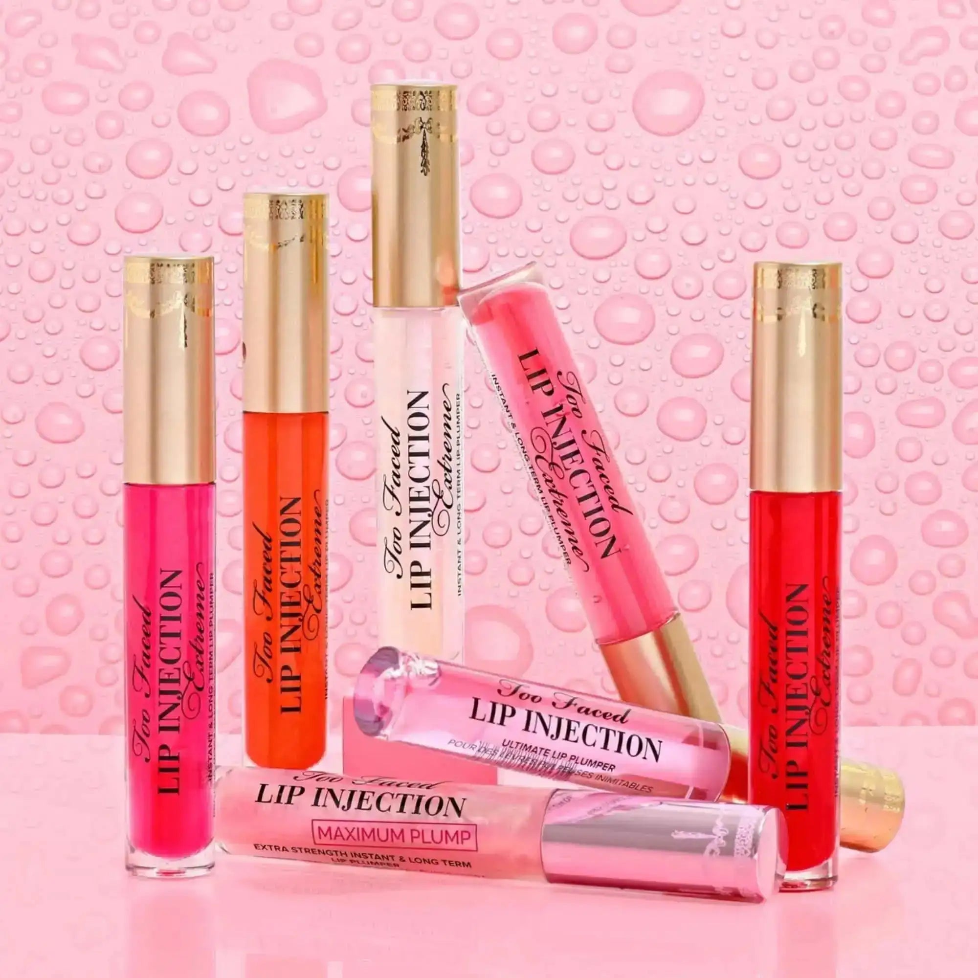 Too Faced Lip Injection Extreme Lip Plumper Bubblegum Yum tube lying flat with shiny cap