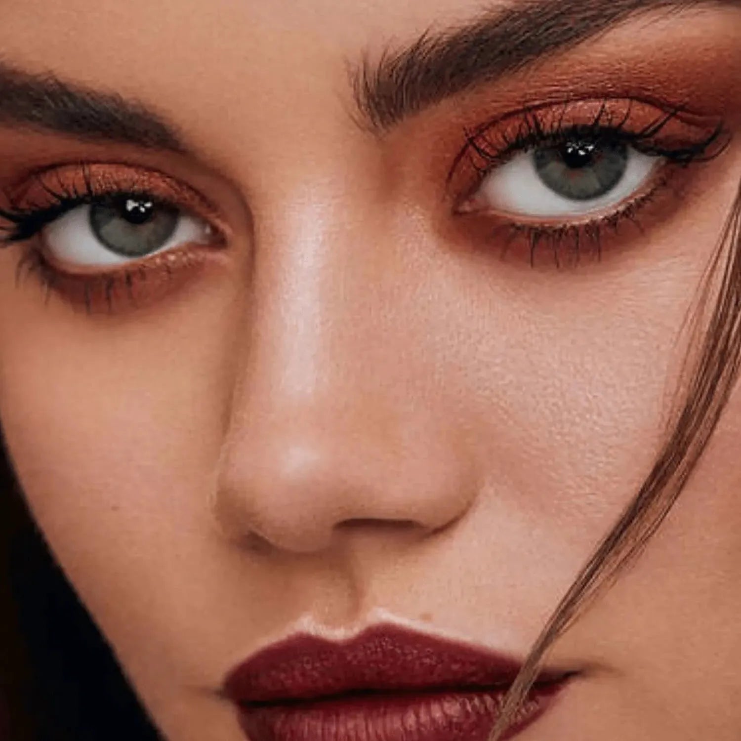 Swatches of Urban Decay Naked Heat palette showing warm tones from light to dark